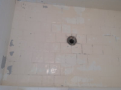 Dallas Bathtub Services removing a layer of epoxy paint that had peeled on the shower floor.