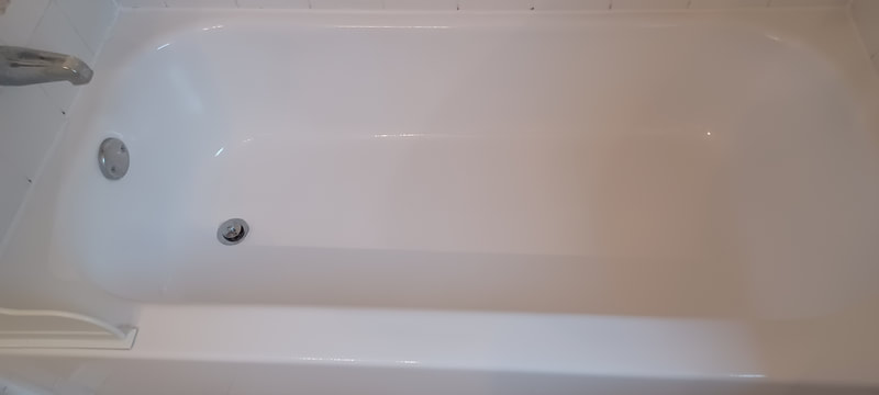 A glossy white polyester fluoropolymer coating was chemically welded to the old surface. Bringing new life back the bathtub with a 20 year life expectancy. Dallas Bathtub Refinishing Services