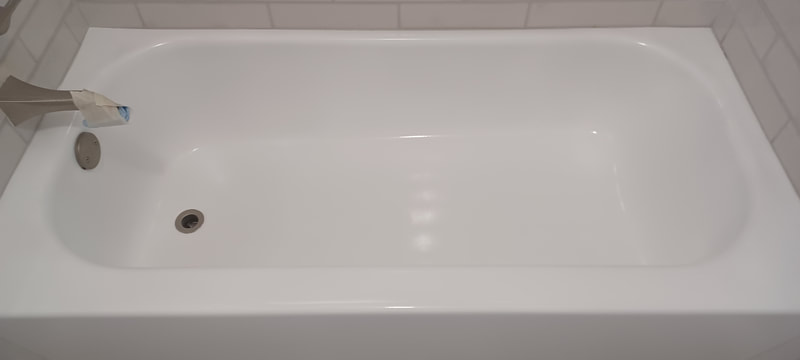 Glossy white polyester fluoropolymer coating chemically welded to the old surface. 20 year like expectancy. Dallas Bathtub Refinishing